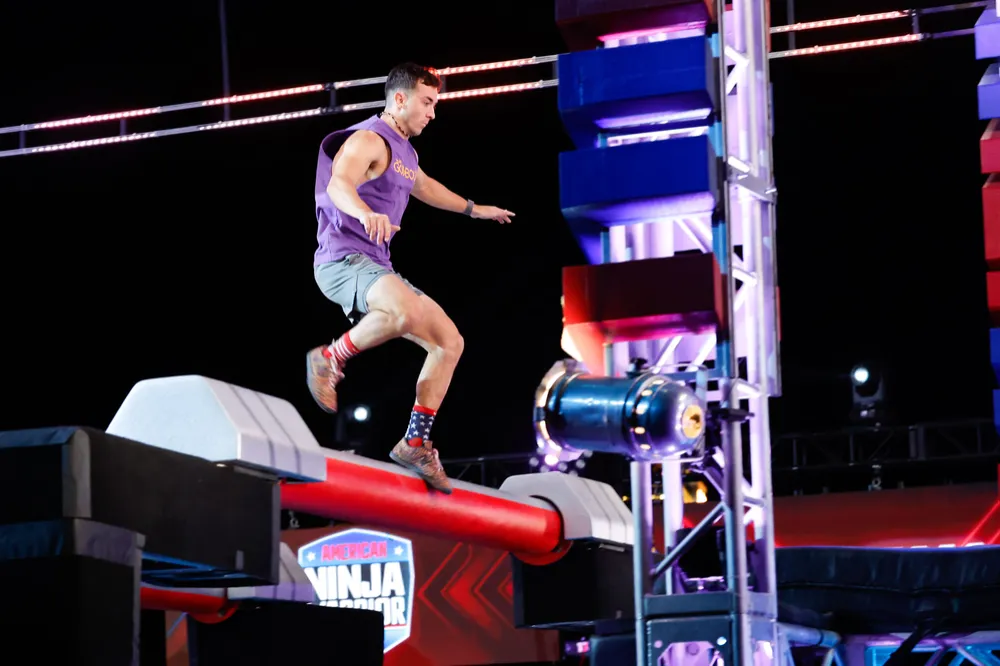 Jonathan landing on a rolling log obstacle