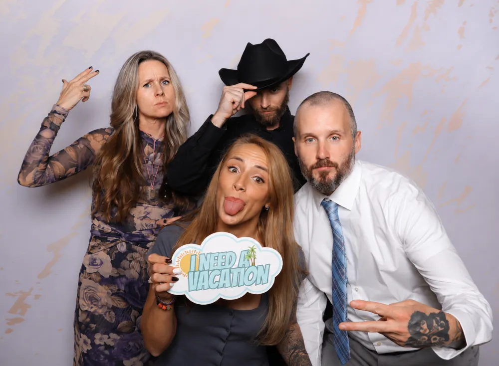 Wedding party laughing together with fun props at a Photo-N-Go booth