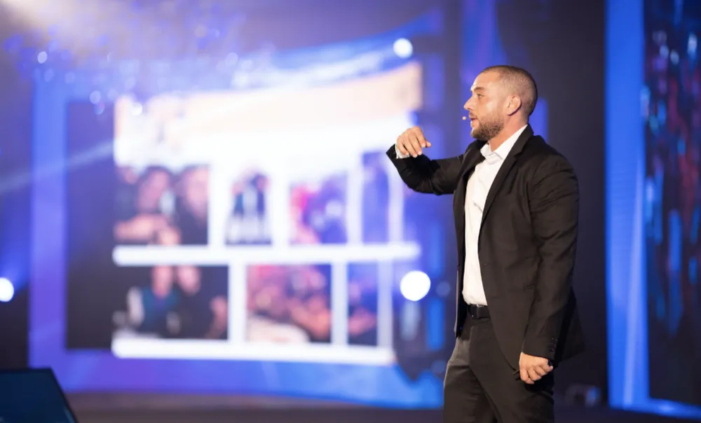 Anthony Rizk, keynote speaker, on stage at a corporate event in the Middle East