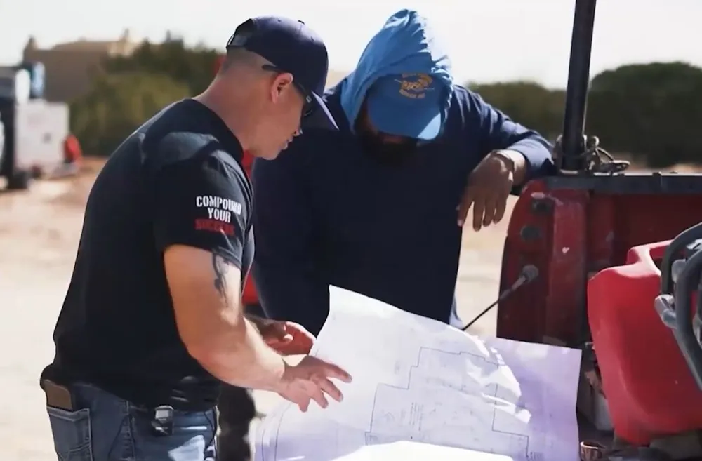 Jerome Maldonado reviewing build plans on site
