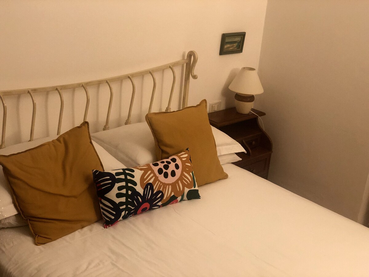 Double bedroom with iron bed frame and bedside lamps