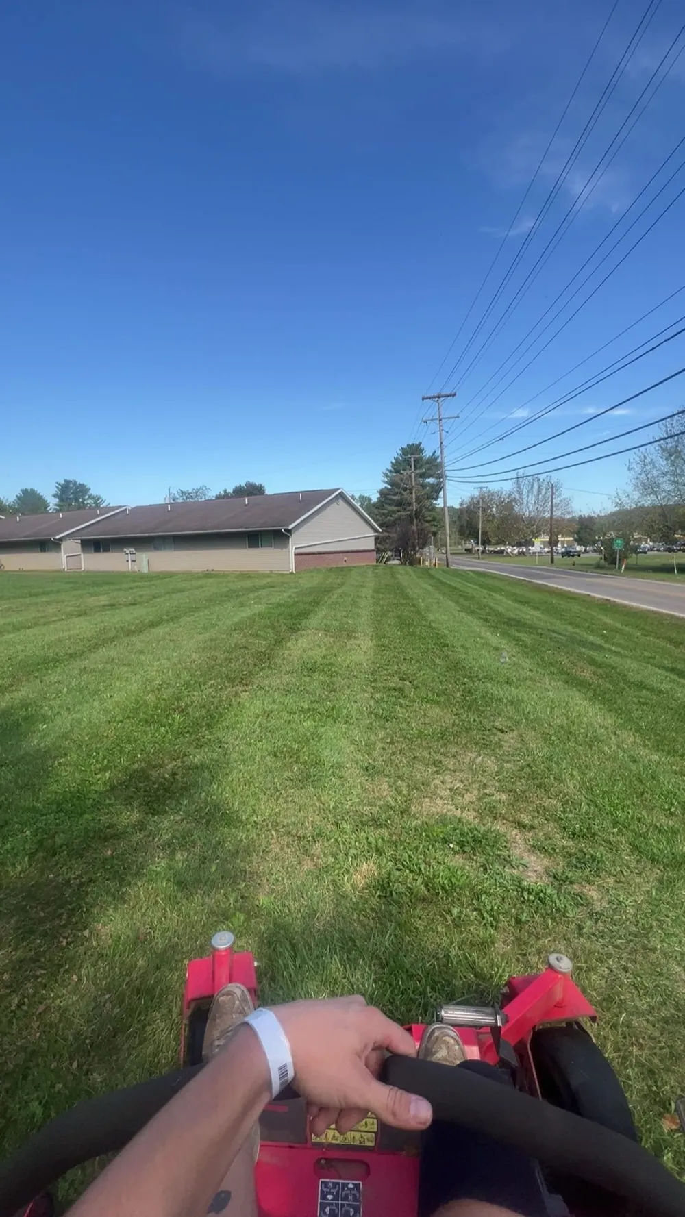 Mowing a green lawn from behind the deck of an A2Z mower