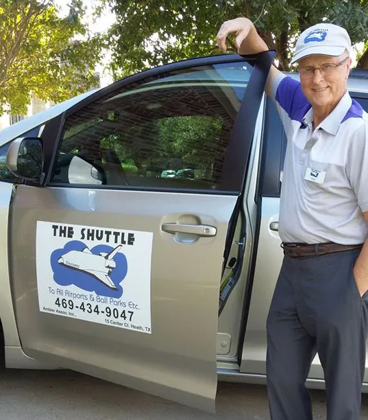 Peter Ambler, owner of The Shuttle, beside his Toyota minivan in Rockwall, TX