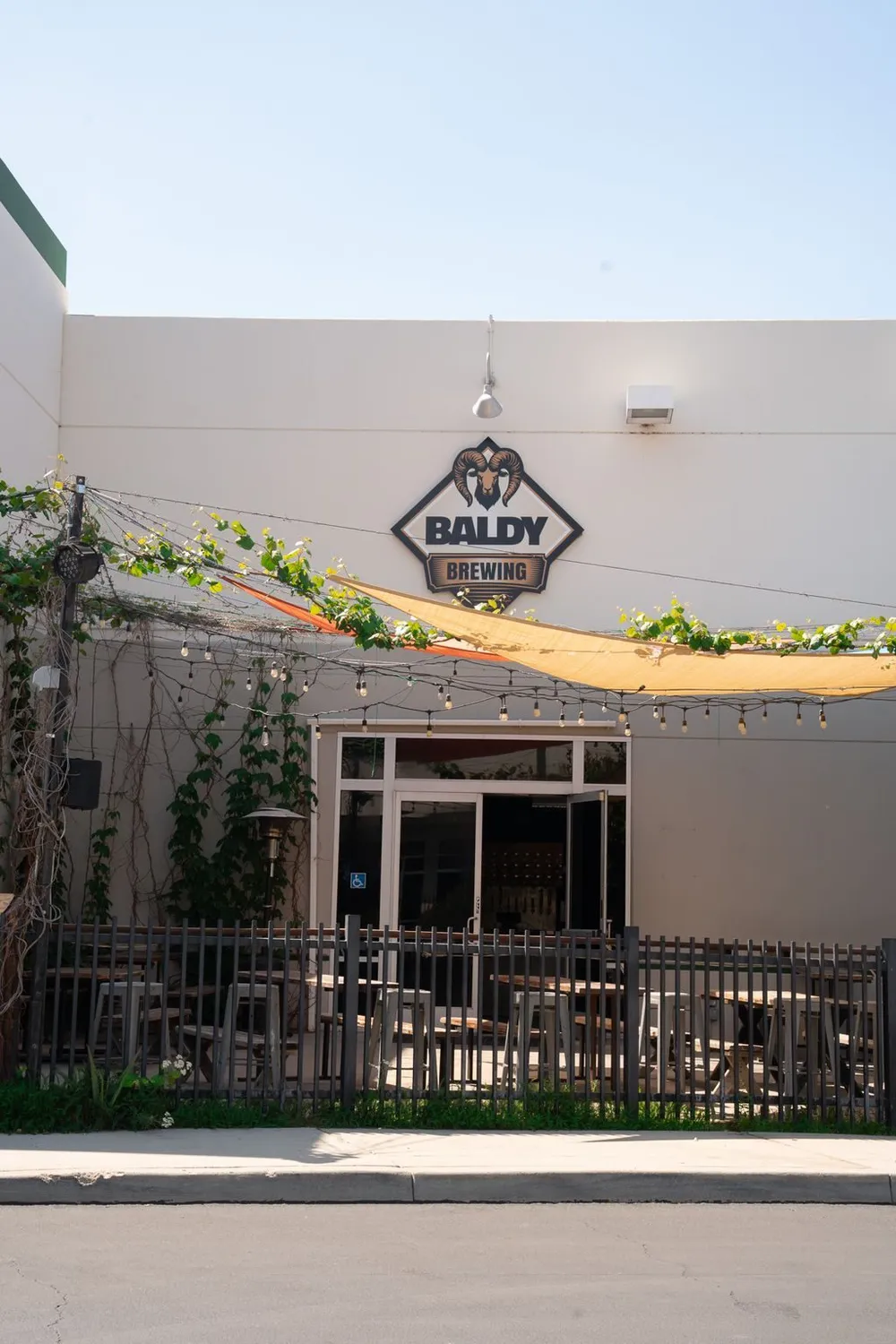 The front of the Mt Baldy Brewery building with its logo sign and patio entrance