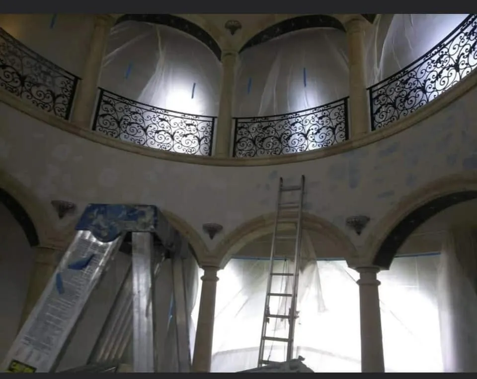 Rotunda with arches and a balcony prepped for painting