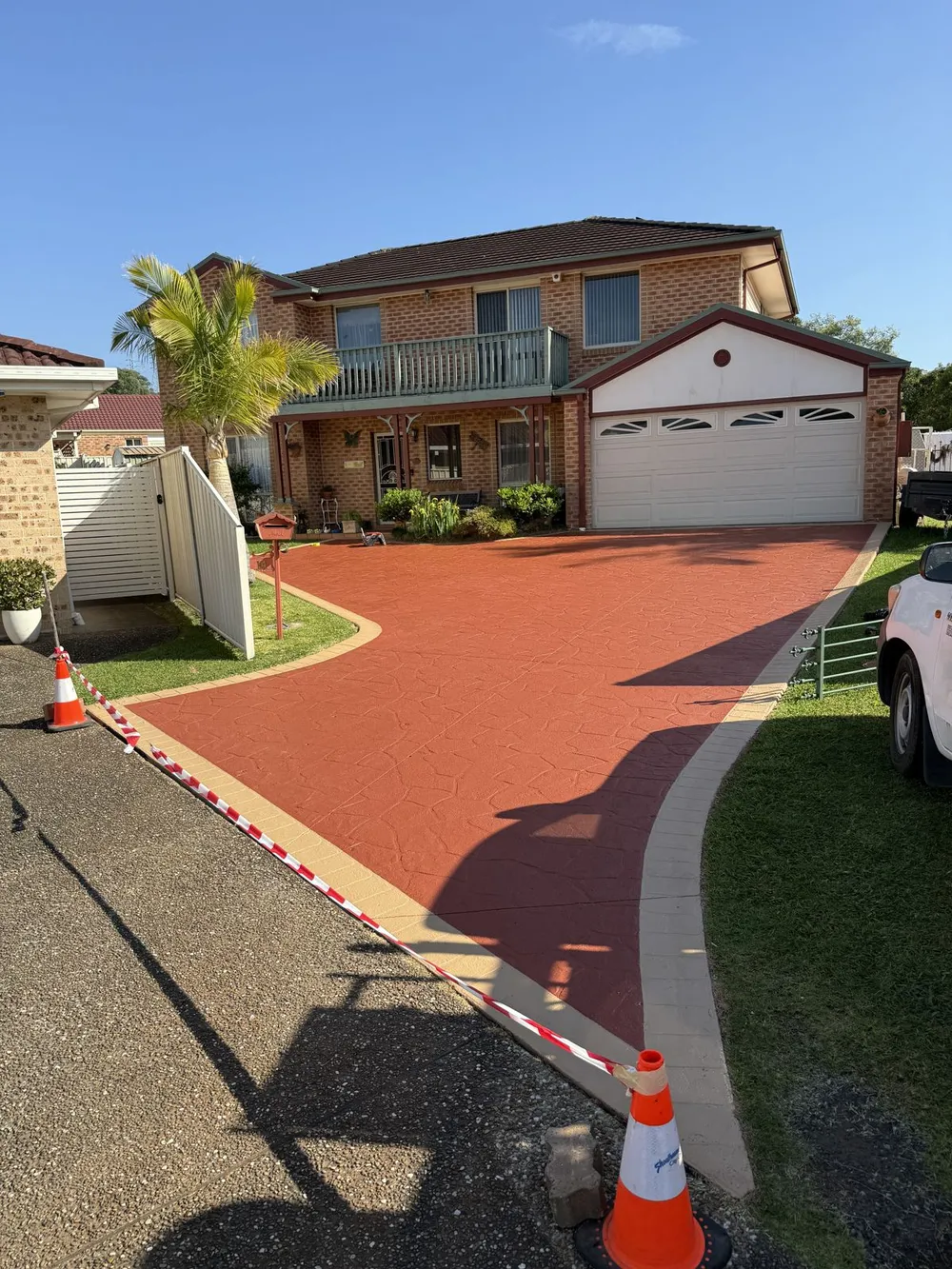 Stamped concrete driveway after cleaning and colour sealing