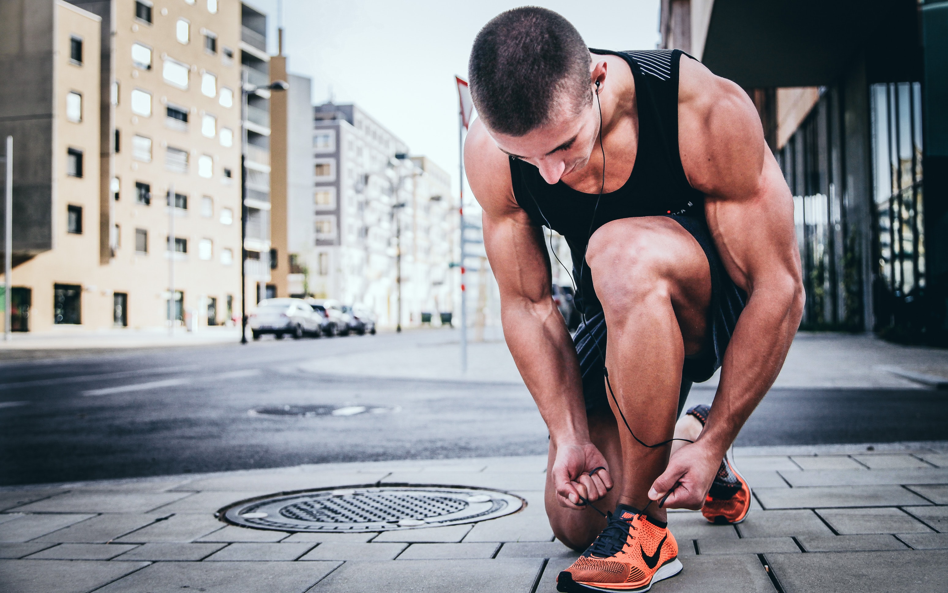 A runner tying his shoes