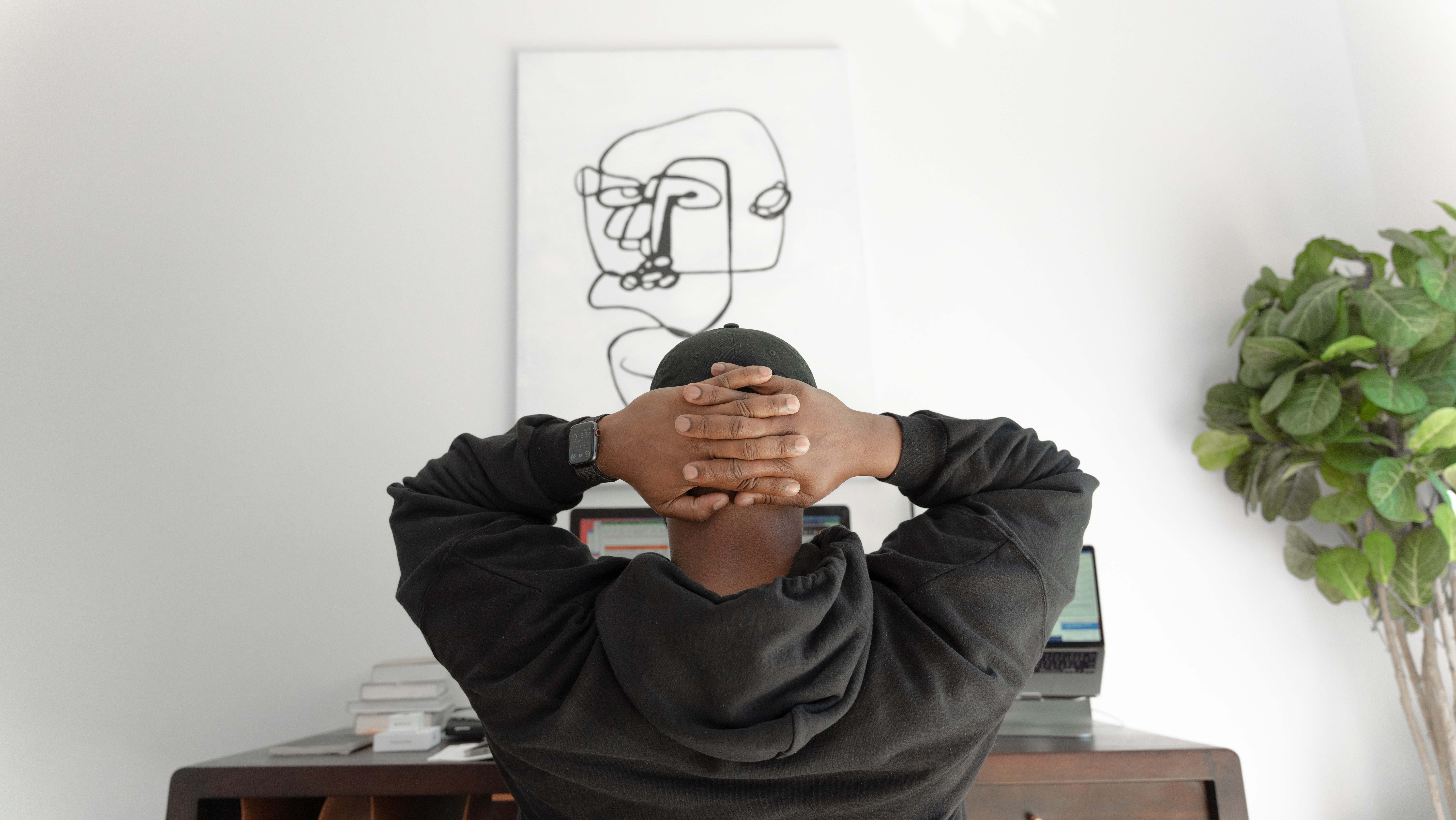 A man taking a moment at his desk