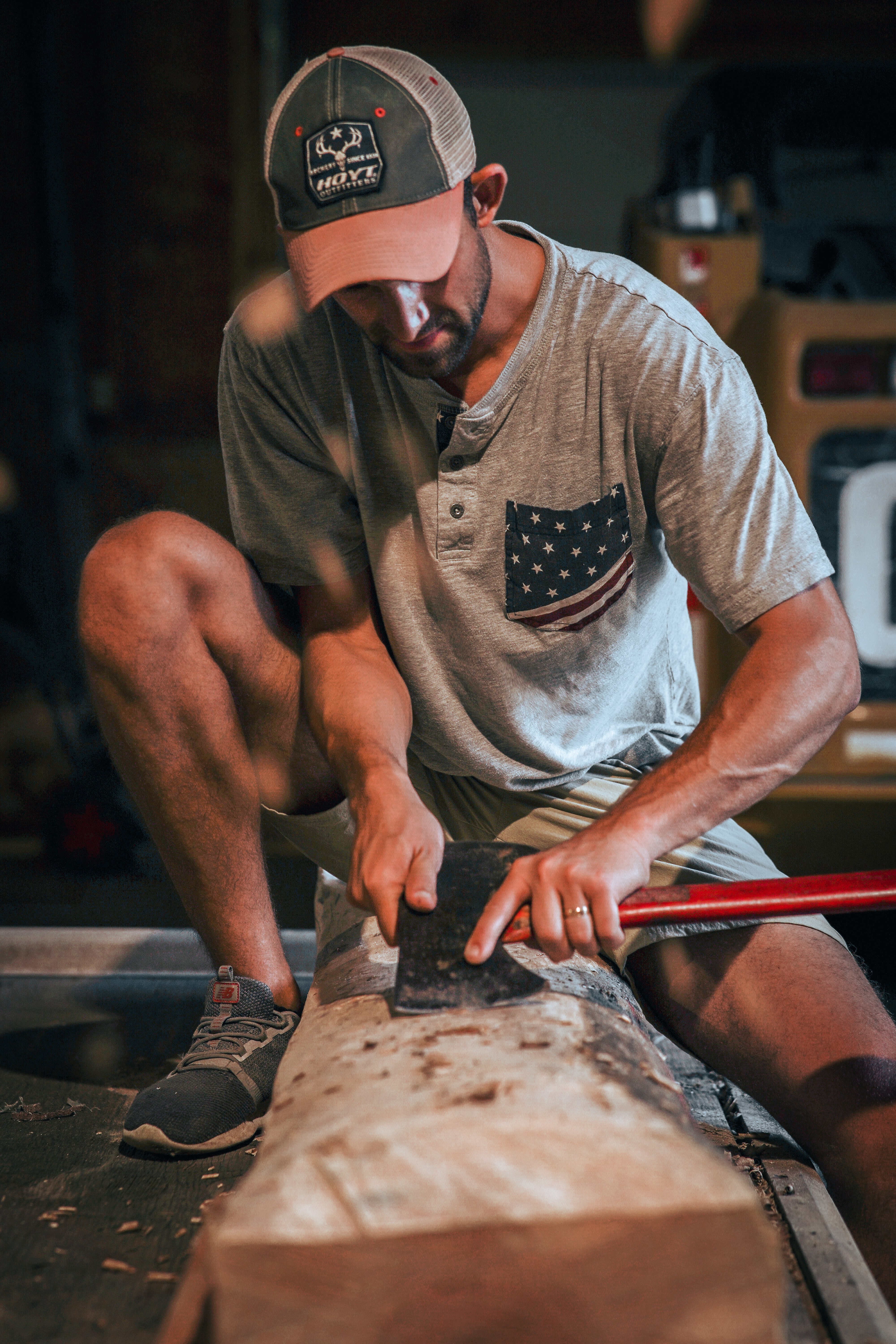 A man shaping wood by hand