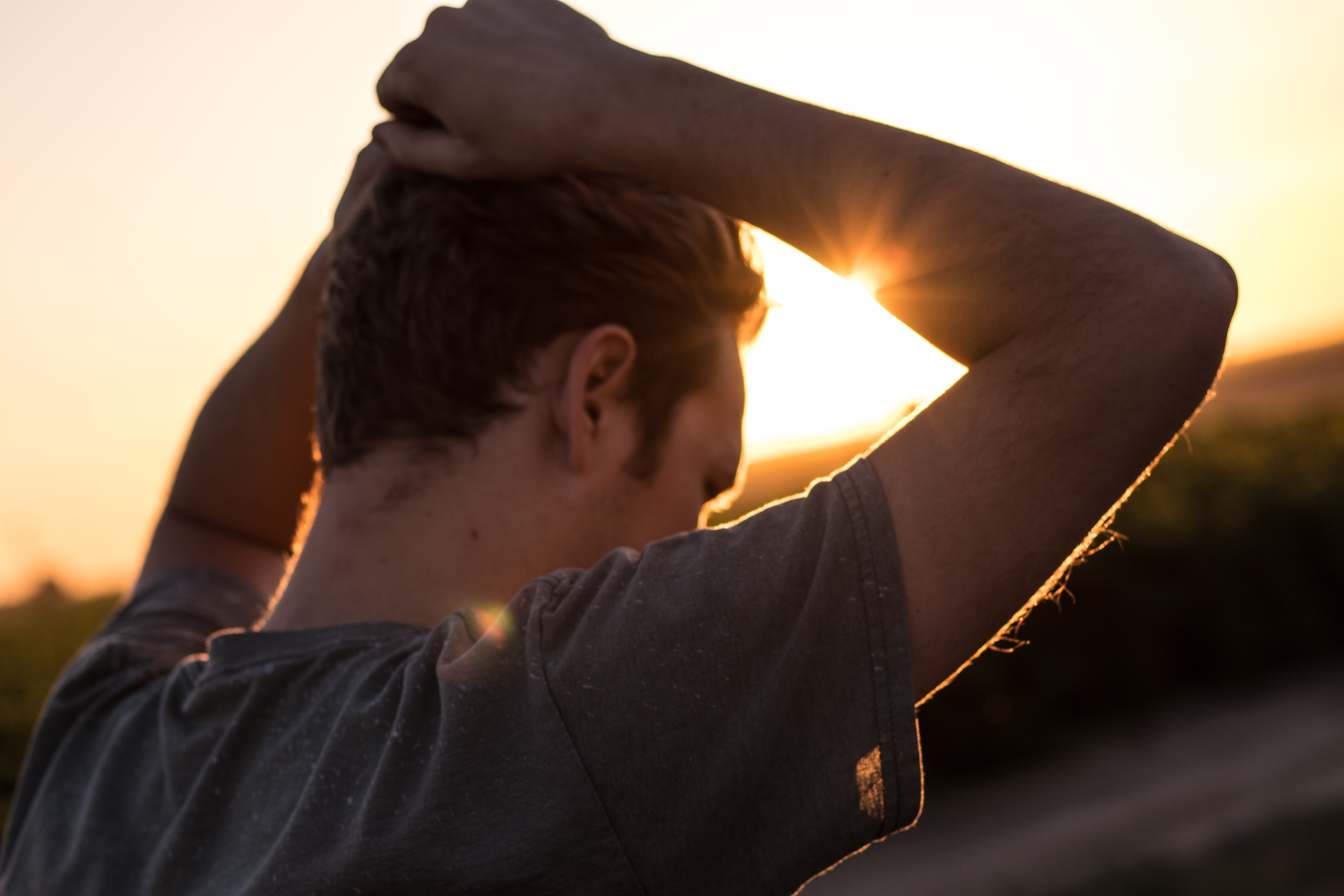 A man outdoors at sunset