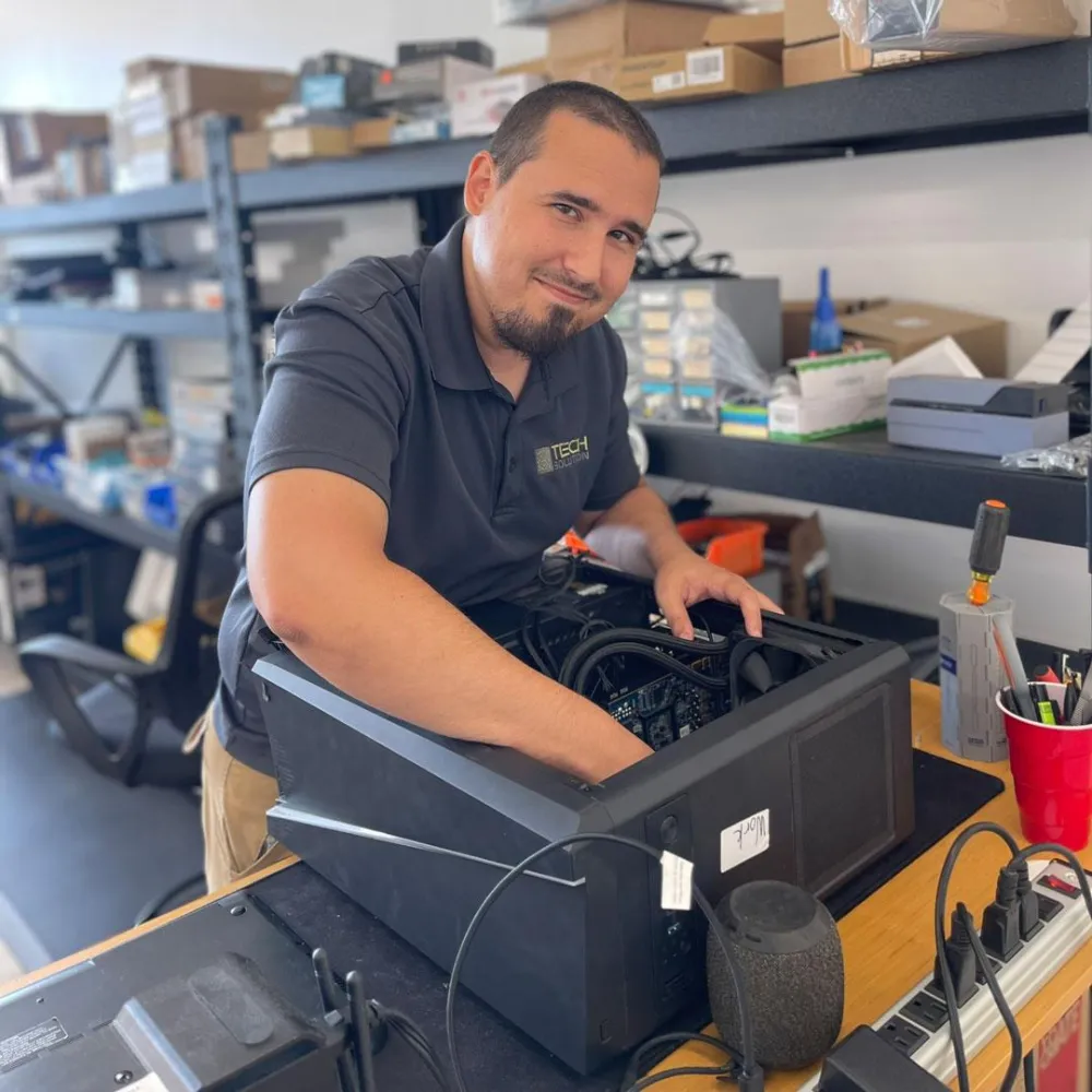 Dan, Owner, working on a computer at Tech Solution, Gulf Shores AL