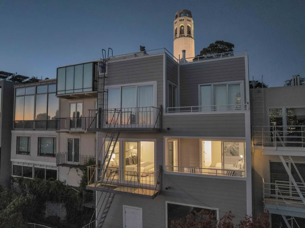 Twilight photo of a Telegraph Hill home with Coit Tower behind it