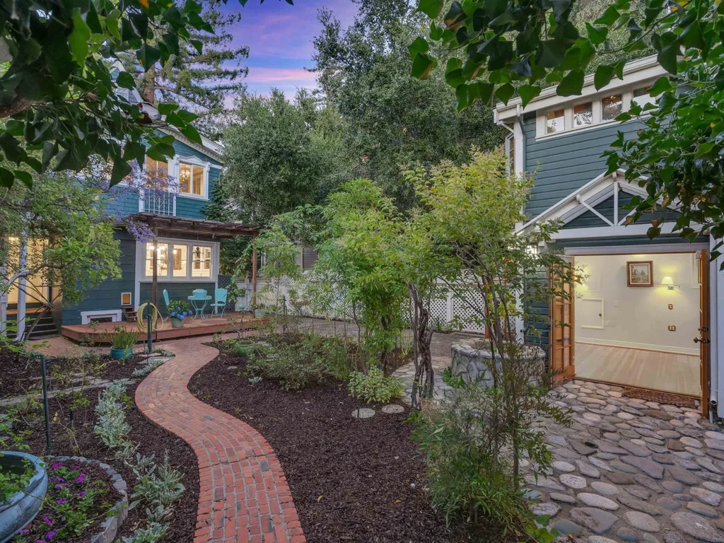 Twilight photo of a garden path leading to a guest house