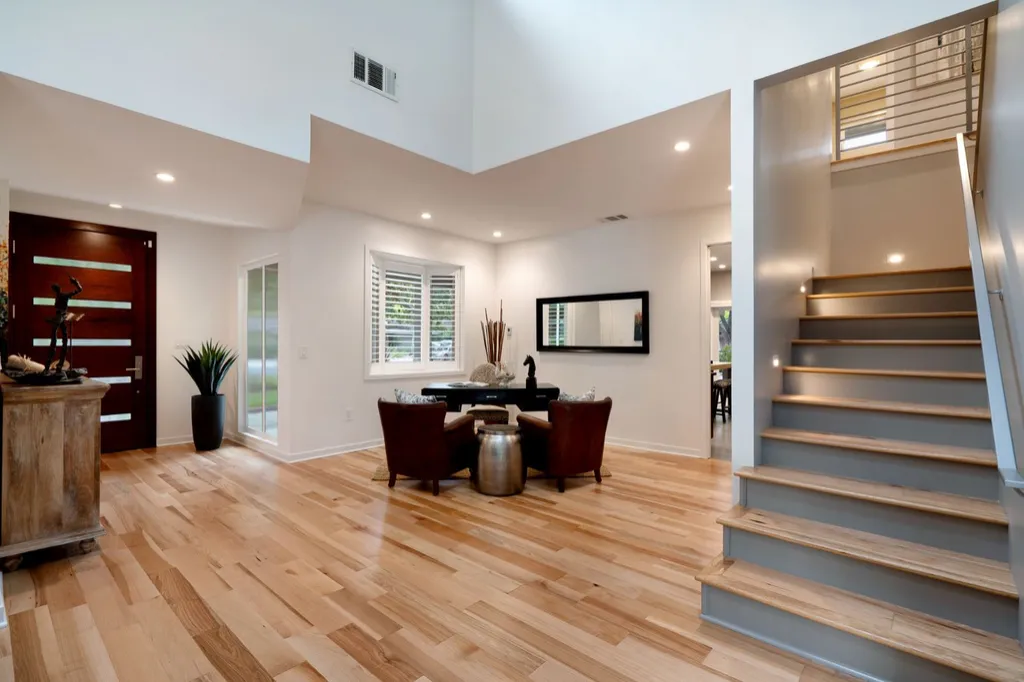 Entry hall with an open staircase and hardwood floors