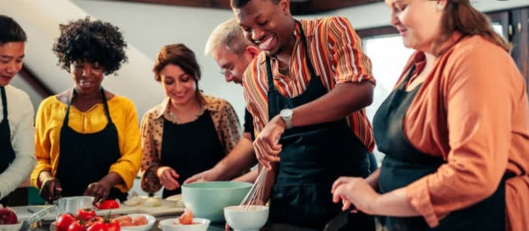 Adults cooking together in a hands-on class