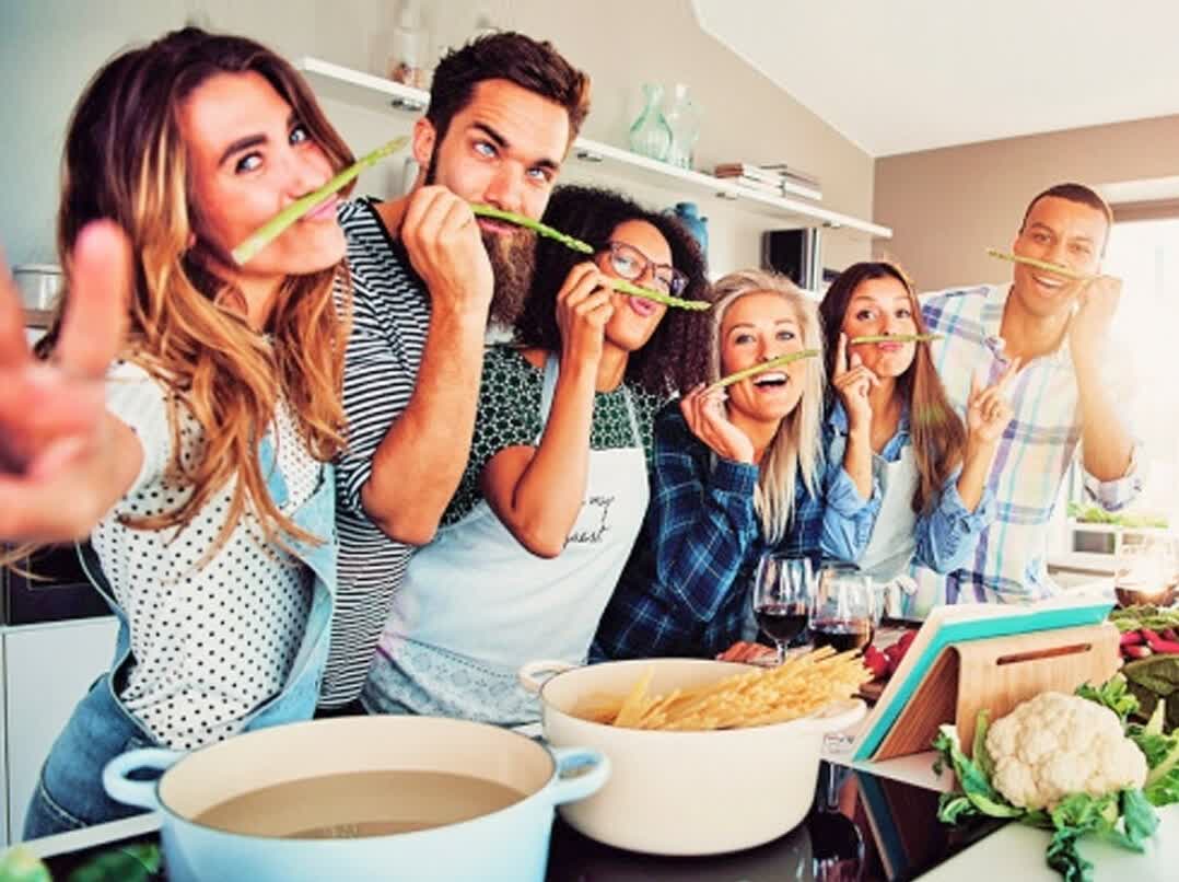 Adults laughing together in an adult cooking class