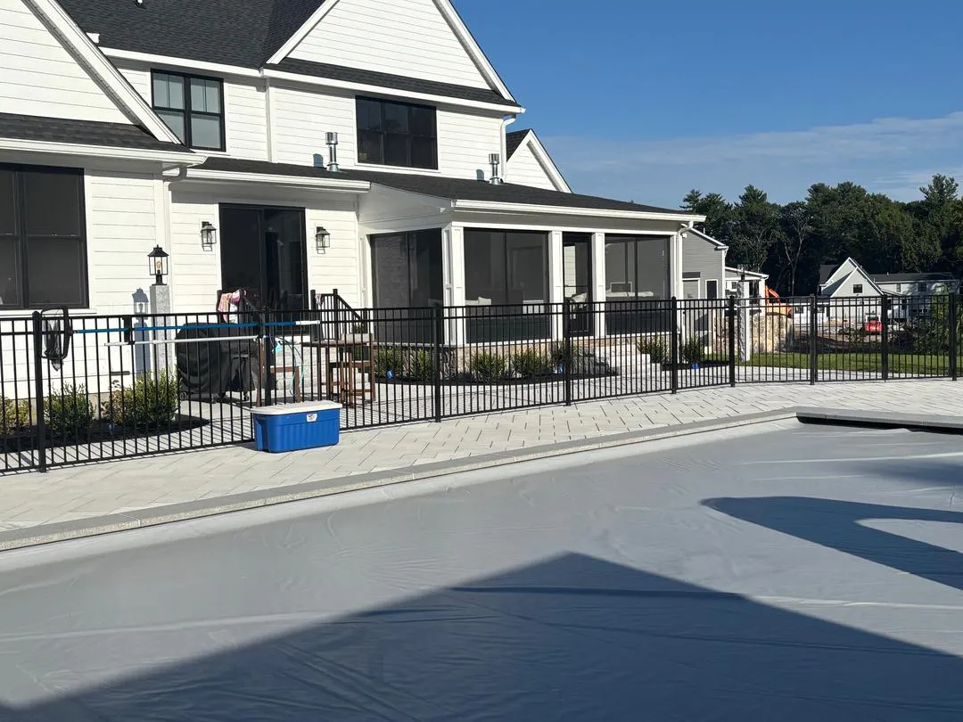 Black aluminum fence around a backyard pool by All Fenced In