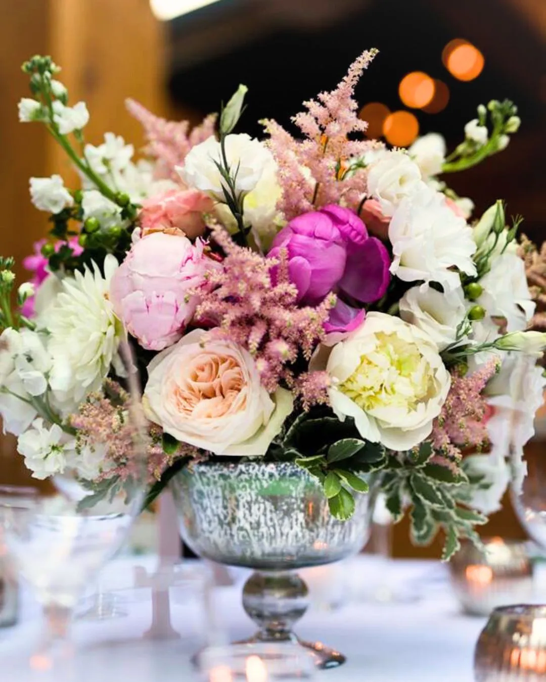 Pink astilbe and peony arrangement in a mercury glass vase