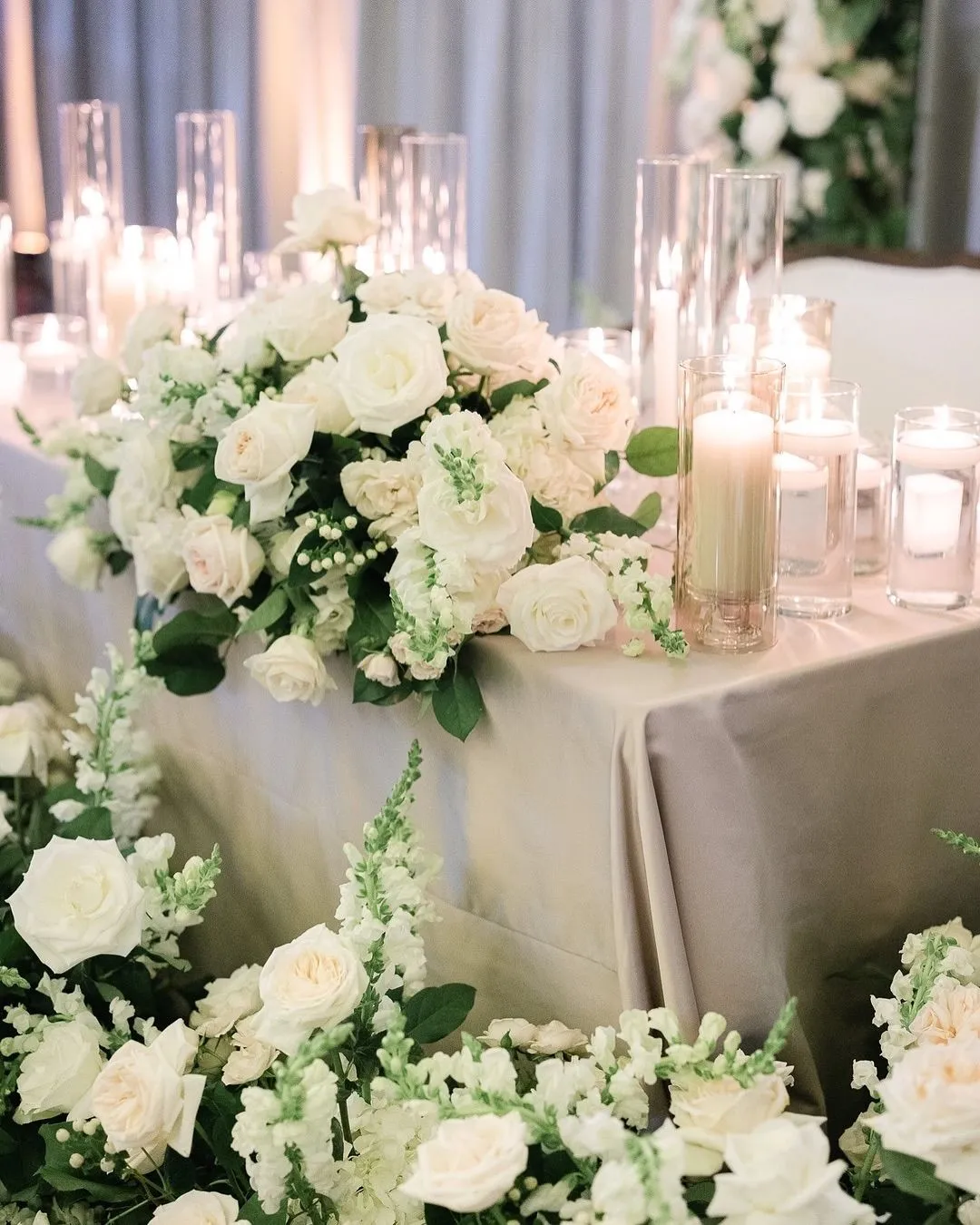 White rose and hydrangea head table arrangement with candles