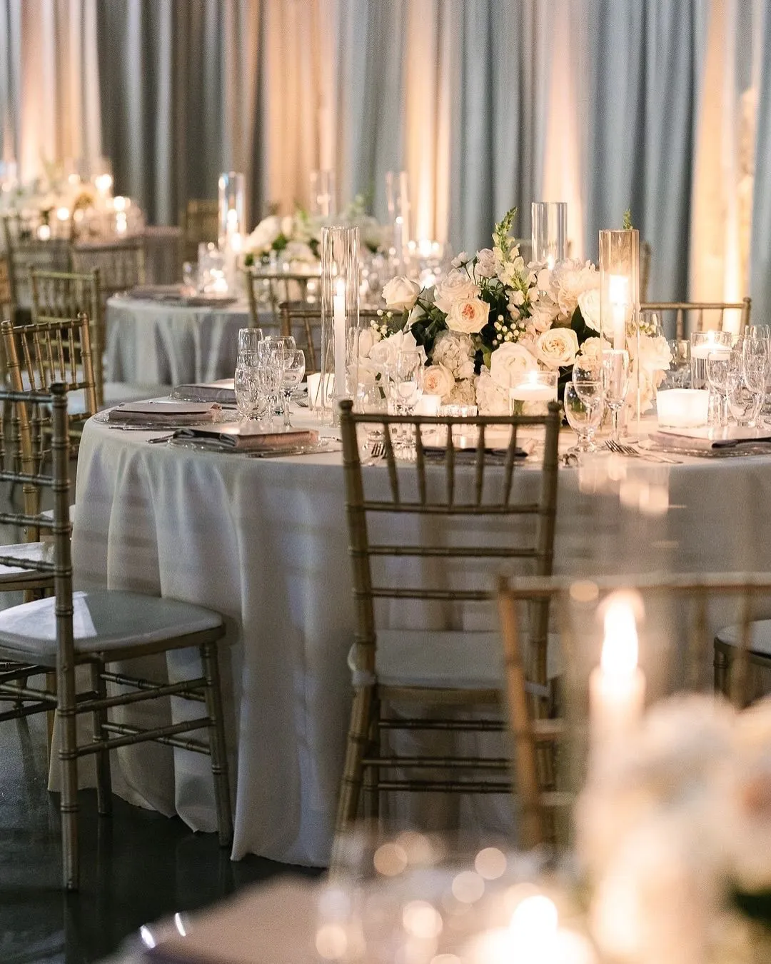 Candlelit reception tables with white and blush centrepieces