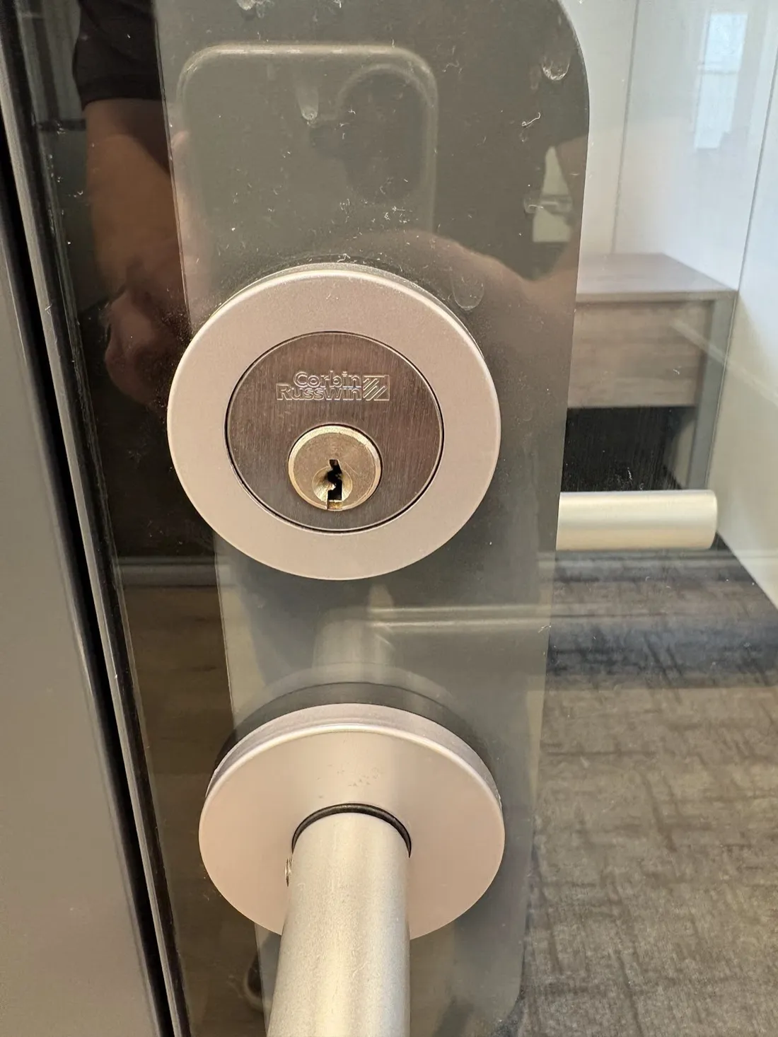 Commercial deadbolt and lever handle on an office door