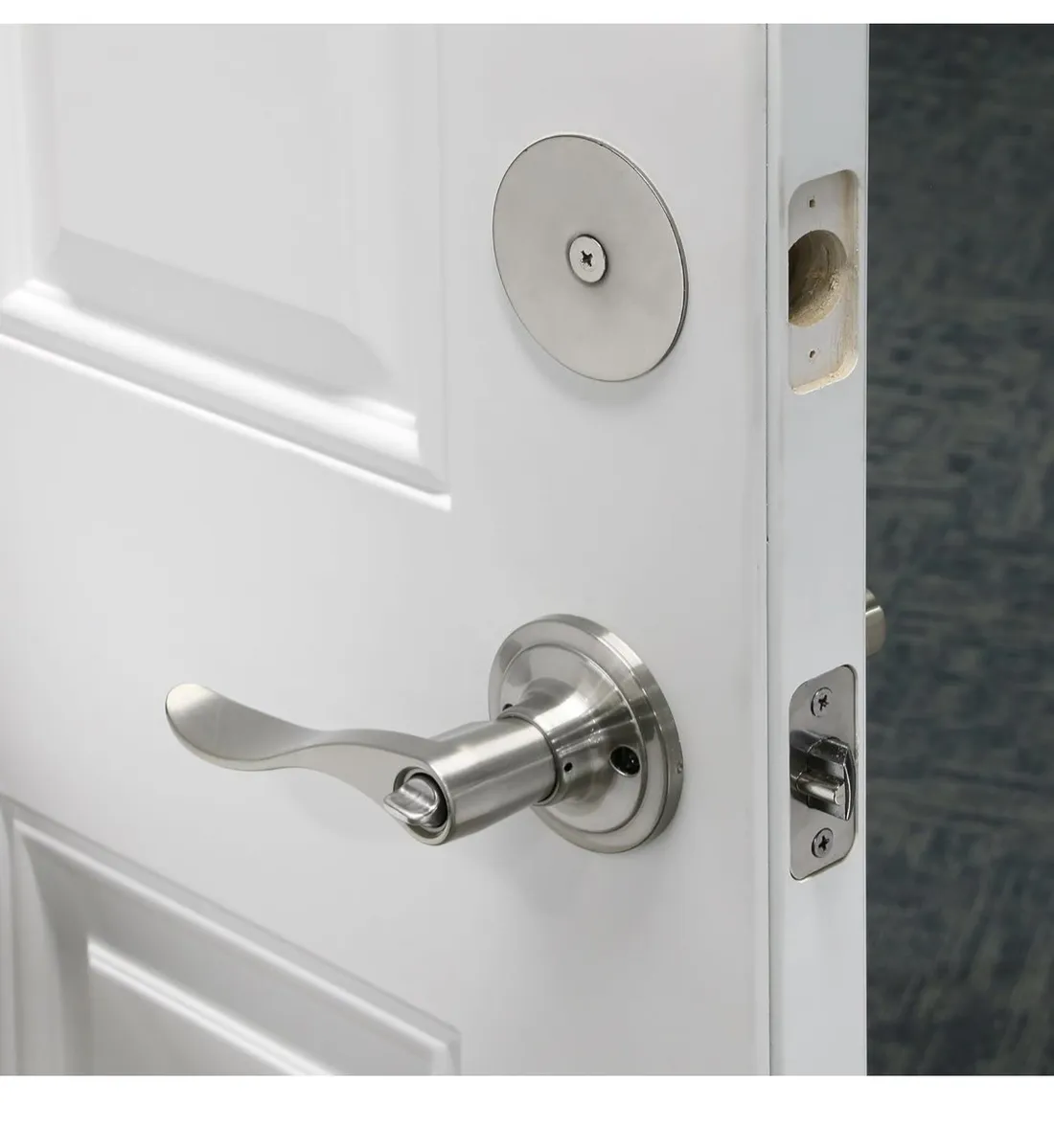 Door lever lock and deadbolt on a white door
