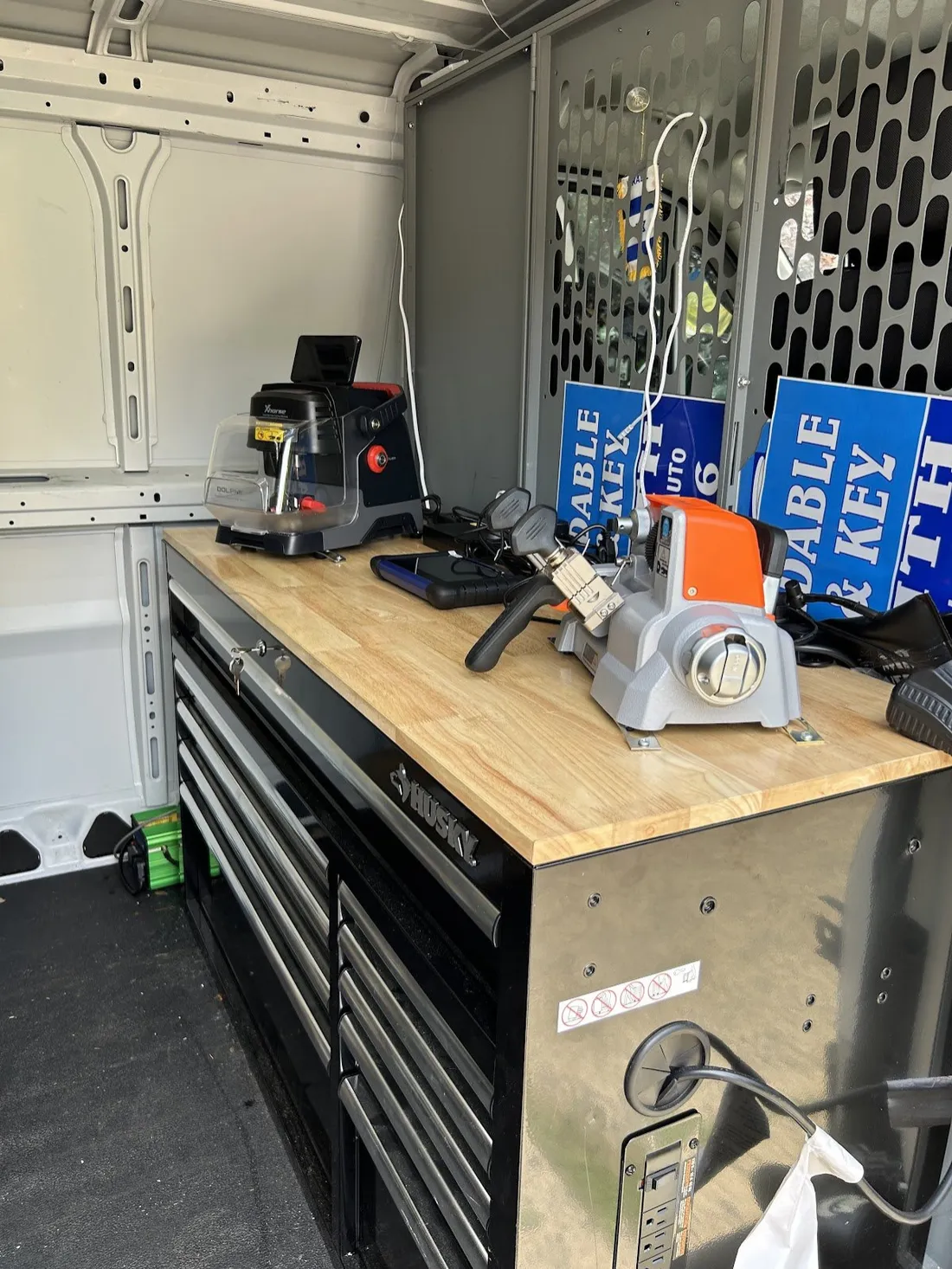Key cutting machine on the workbench of the mobile locksmith van