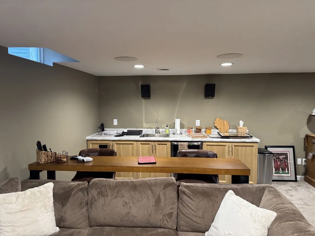 Basement media room with ceiling and wall-mounted surround speakers