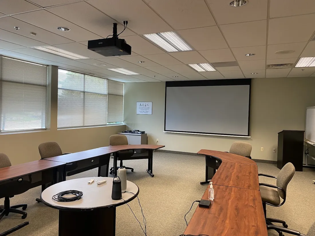 Conference room with a ceiling-mounted projector and pull-down screen