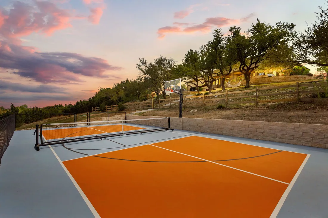 Pickleball court in orange and slate on Hill Country acreage