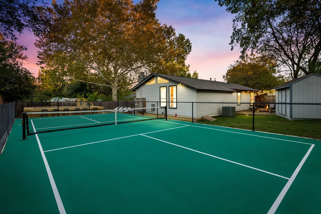 Pickleball court in green at sunset
