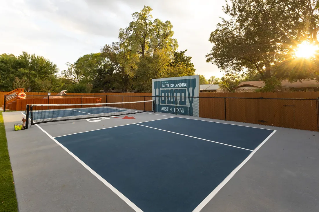 Pickleball court in slate under mature oaks