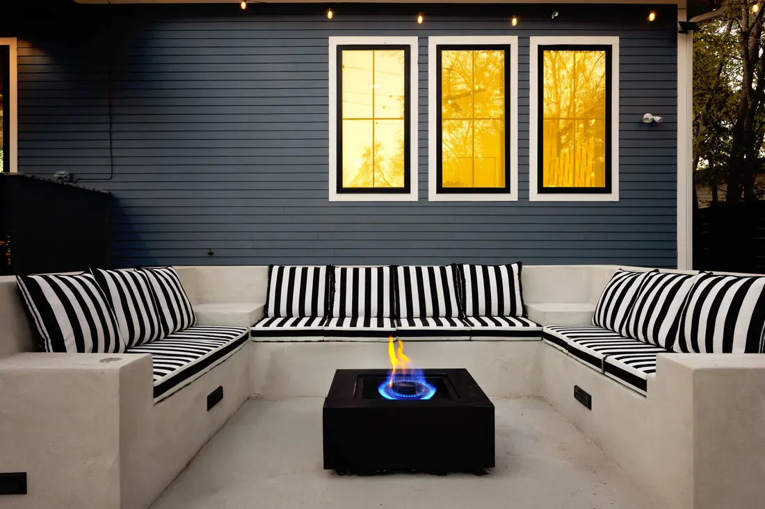 Built-in lounge with fire table on a modern patio
