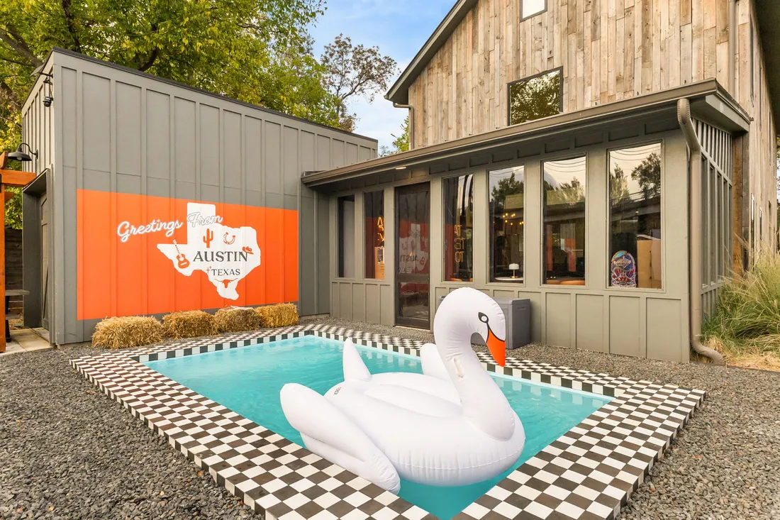 Pool with checkerboard deck and painted mural