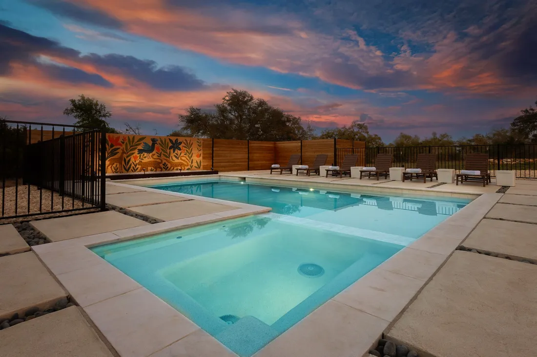 Pool deck with a cool deck coating and a painted mural wall at sunset, Driftwood