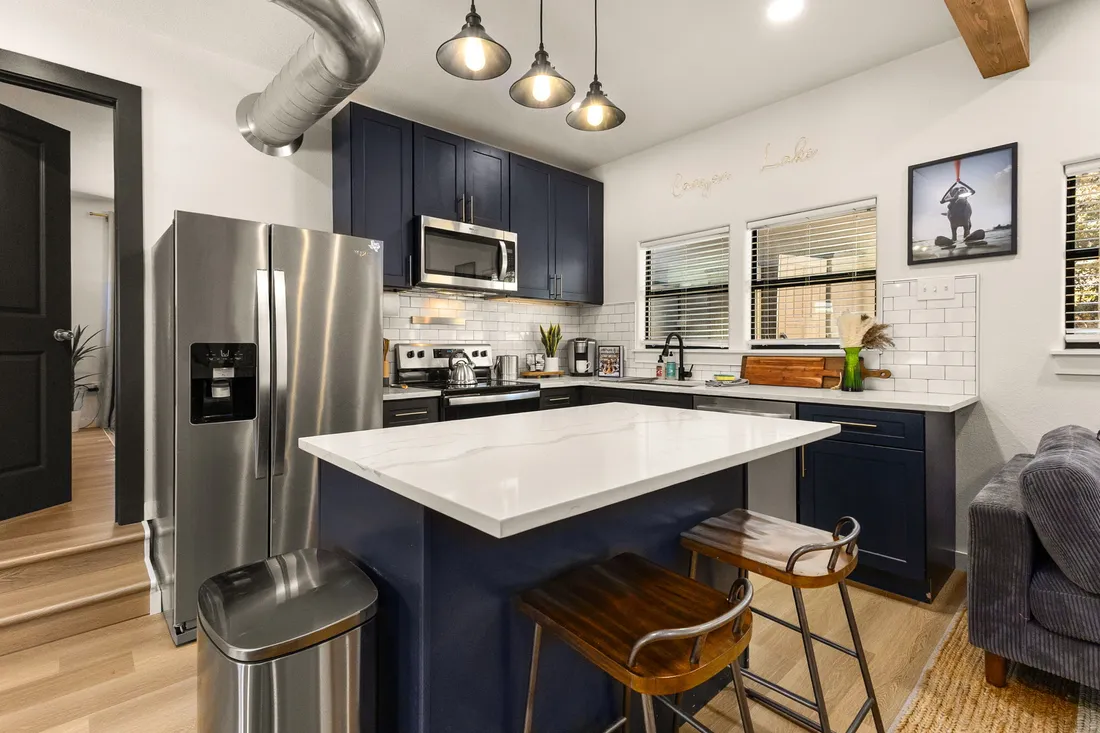 Kitchen with navy cabinets and a white island