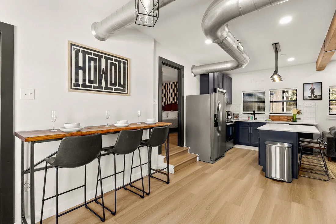 Kitchen with bar seating and exposed ductwork