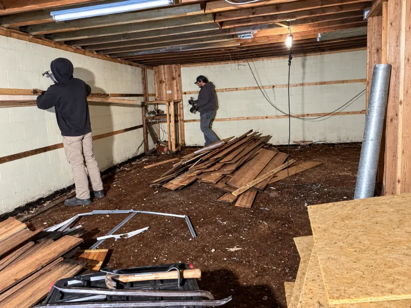Crew removing wall panels during an interior demolition