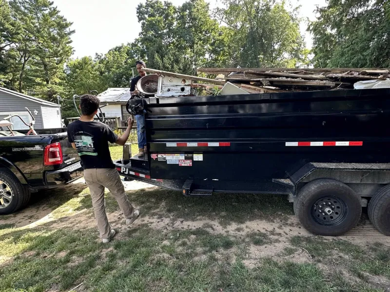 Pickup truck and dump trailer loaded with debris for a dumpster rental