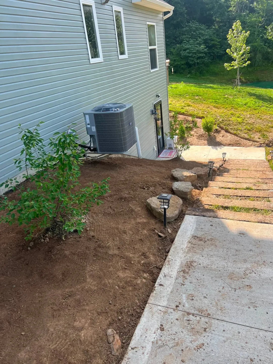 Stone steps set into a slope with new plantings on either side