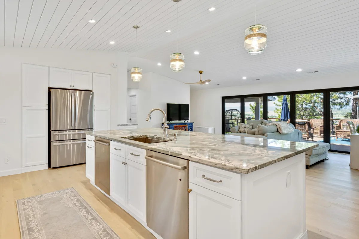 Oak Ridge Dr main photo — Mountain ranch kitchen with white shaker cabinetry, shiplap ceiling, and green quartz countertops.