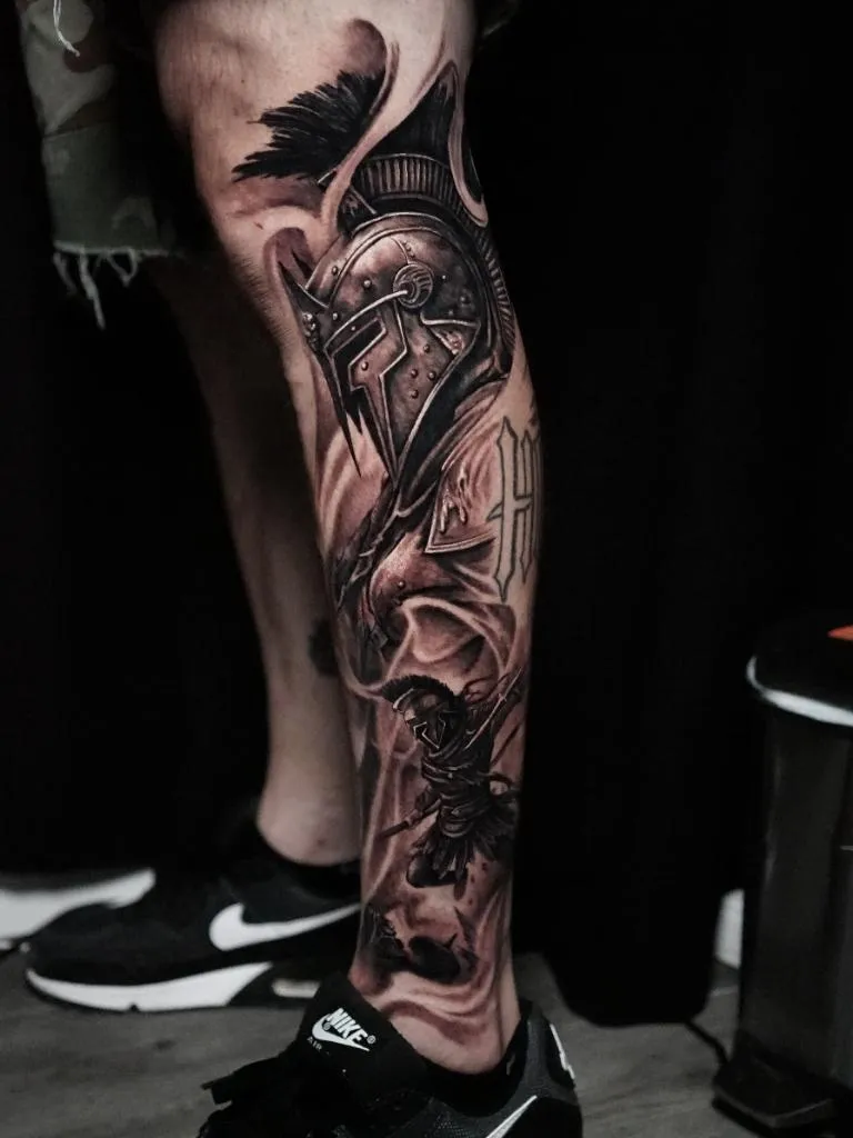 Black and grey Spartan warrior leg tattoo by James Strickland at Montana Tattoo Company in Missoula Montana