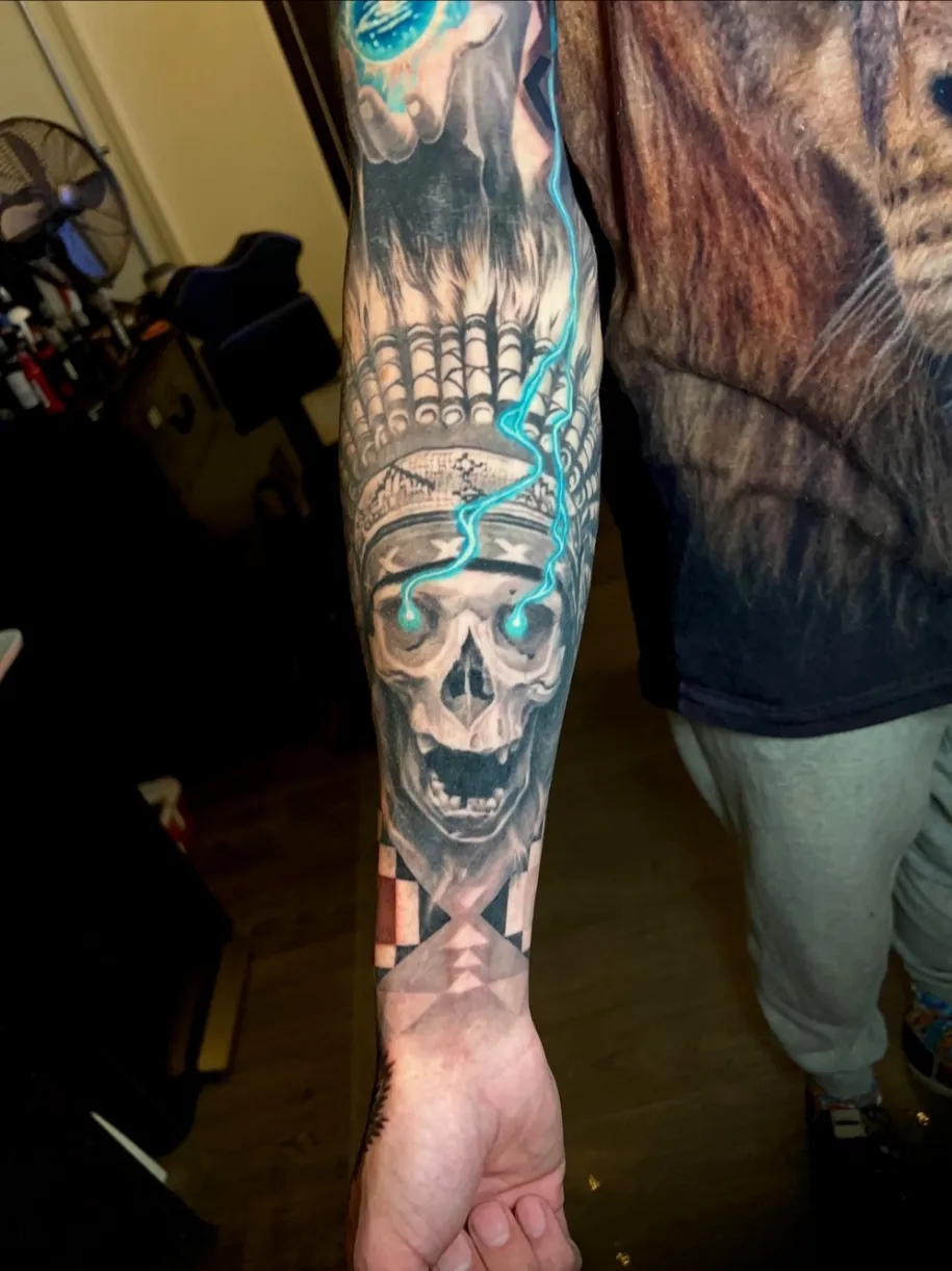 Black and grey skull sleeve with blue accents by Noelin Wheeler at Montana Tattoo Company in Missoula Montana