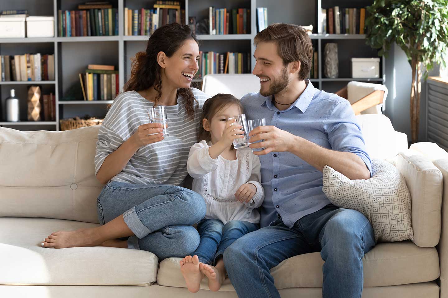 Family enjoying glasses of water at home