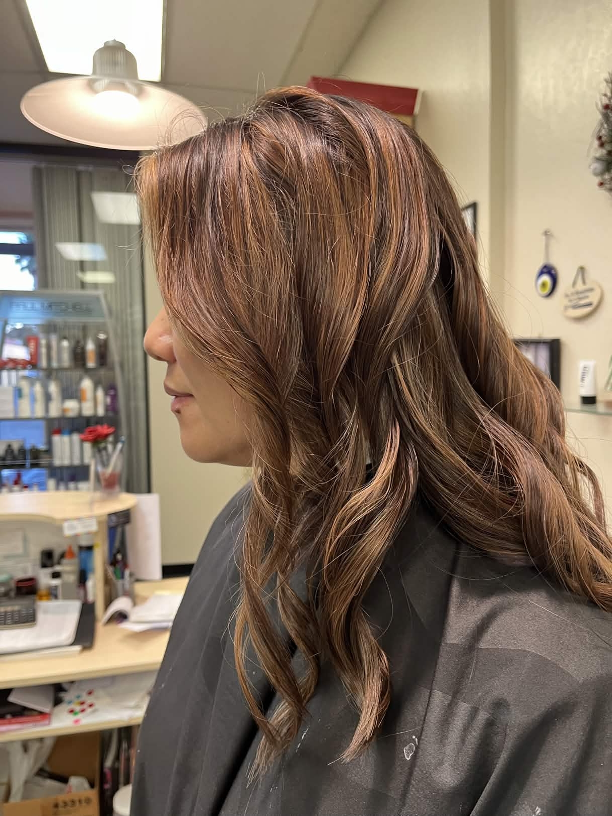 Dimensional brunette balayage with warm highlights and a layered haircut by May Wong at Silver Star Salon in Sacramento