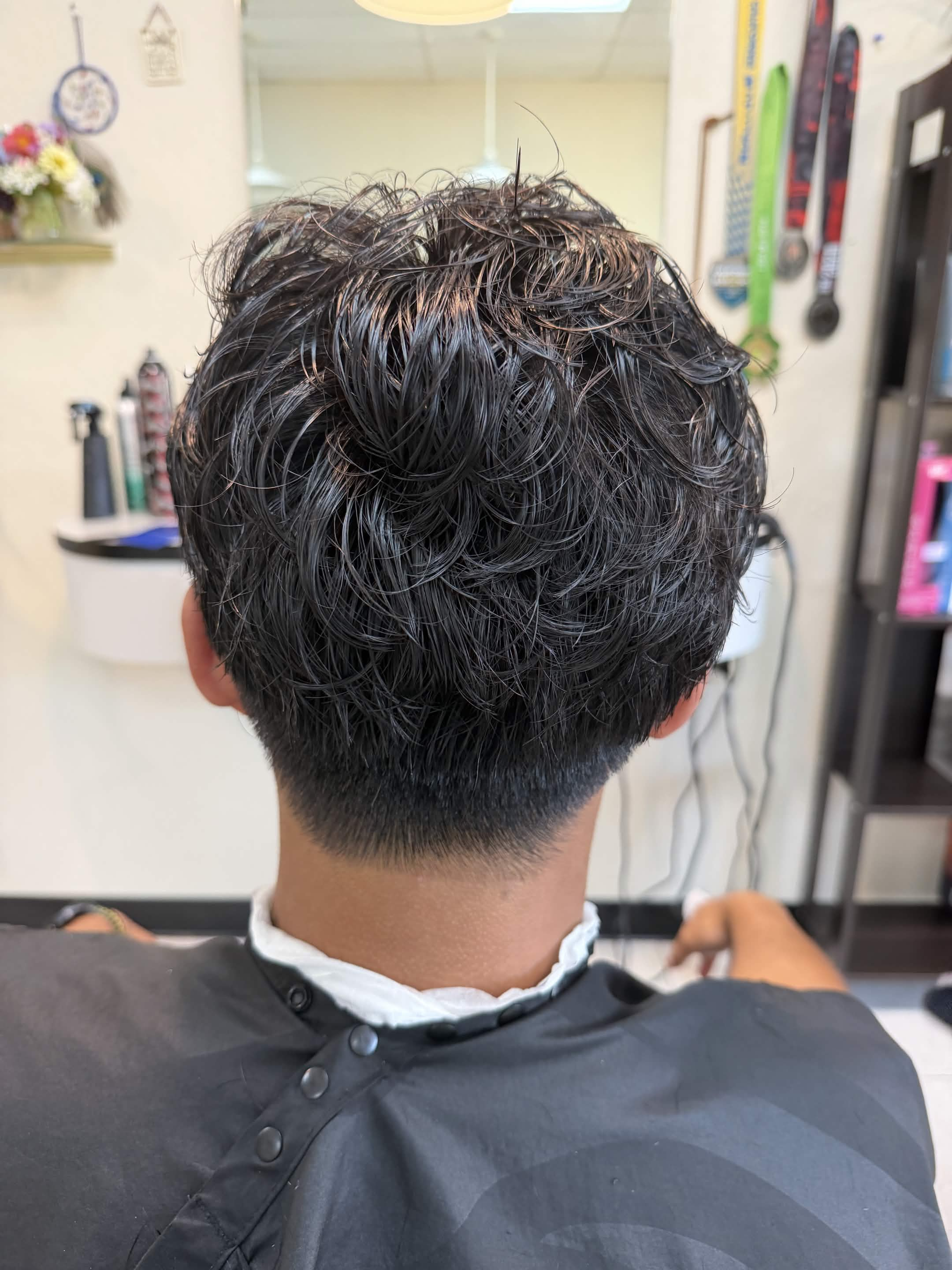 Back view of a men’s textured perm with tapered neckline at Silver Star Salon in Sacramento