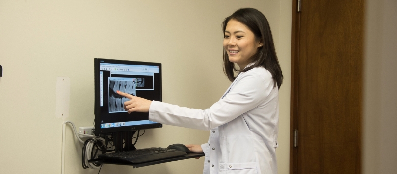 Dr. Hanna Cao reviewing a dental x-ray
