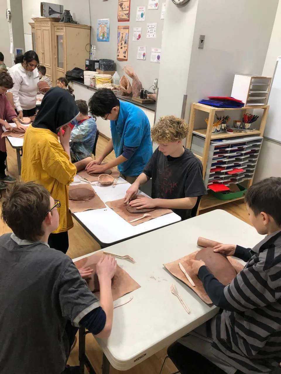 Students working together on a clay project at Evergreen