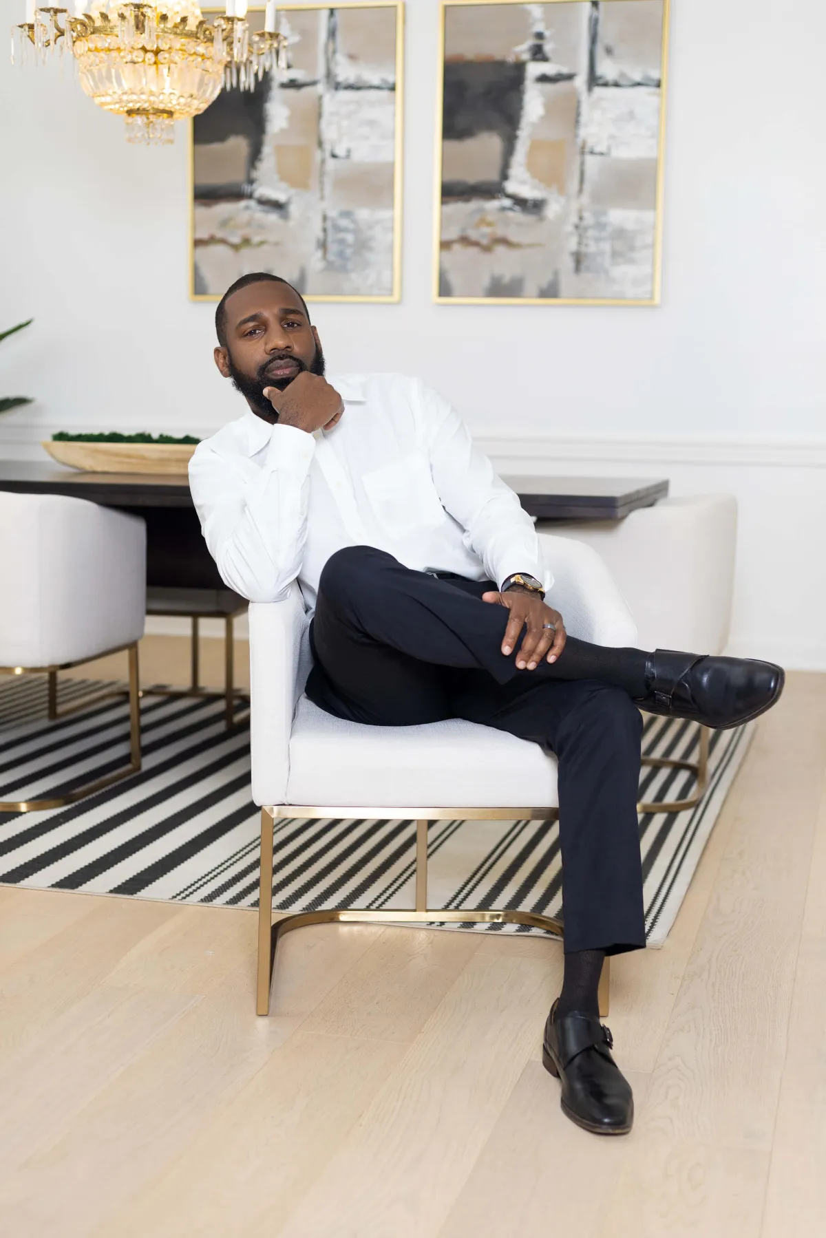 Dr. Marshall L. Thompson Jr. seated in a white chair