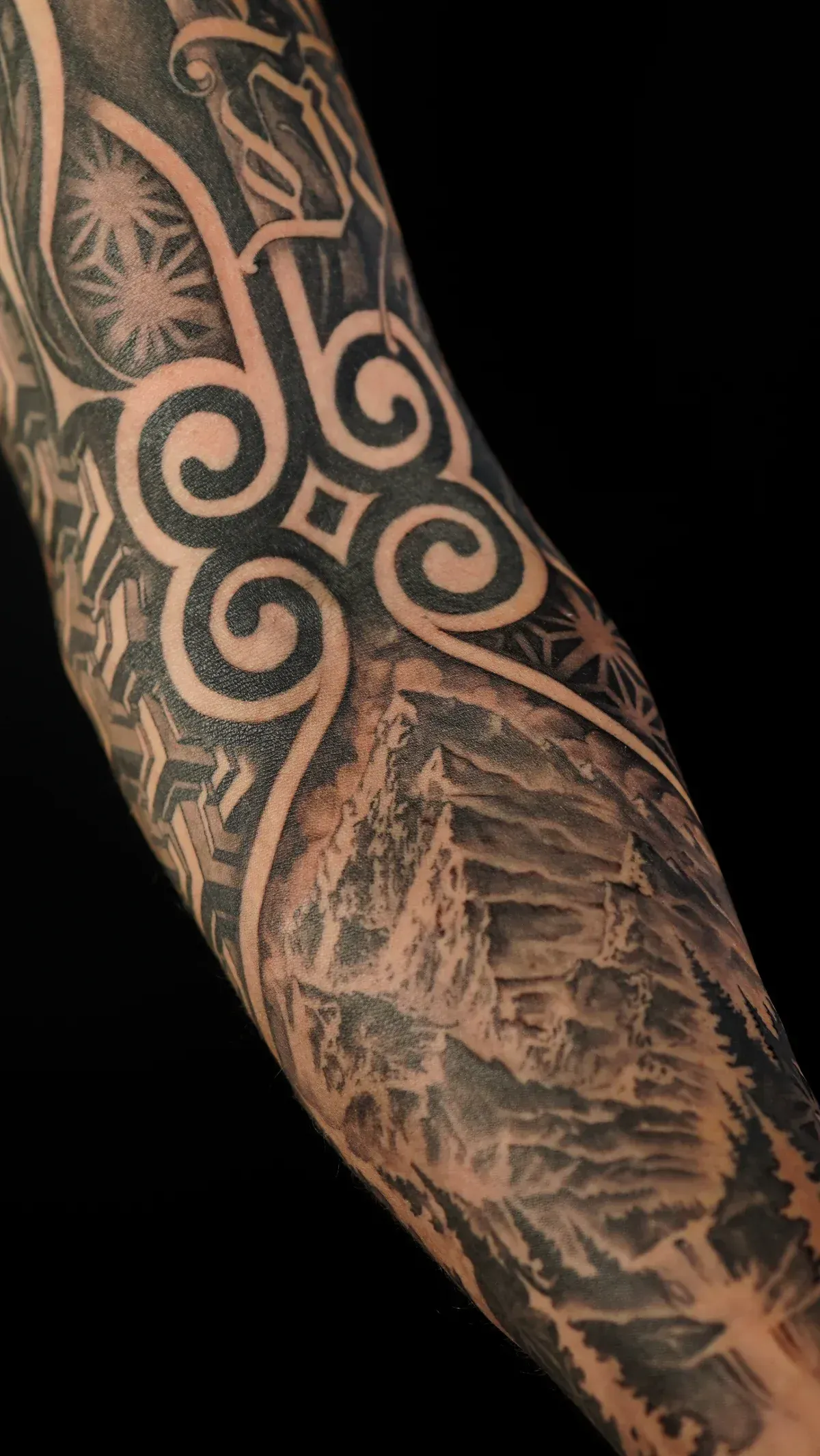 Blackwork geometric mountain tattoo by Mickey Schlick at Montana Tattoo Company in Missoula Montana